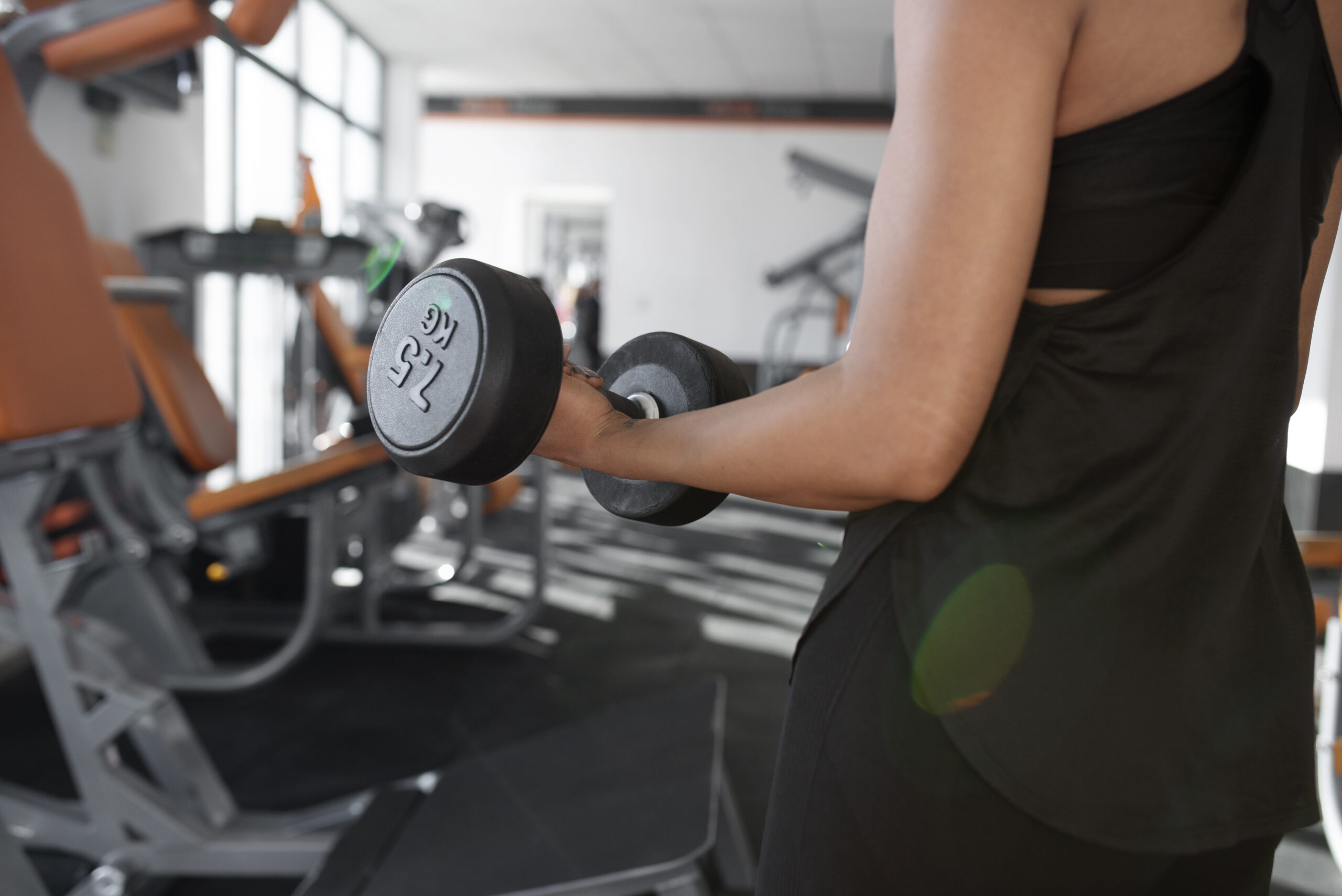 woman-working-out-with-dumbbell-at-gym